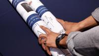 Student opening a poster